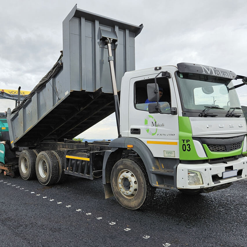 A truck parked on the road, featuring a crane mounted on its top, showcasing a construction or transport scenario.