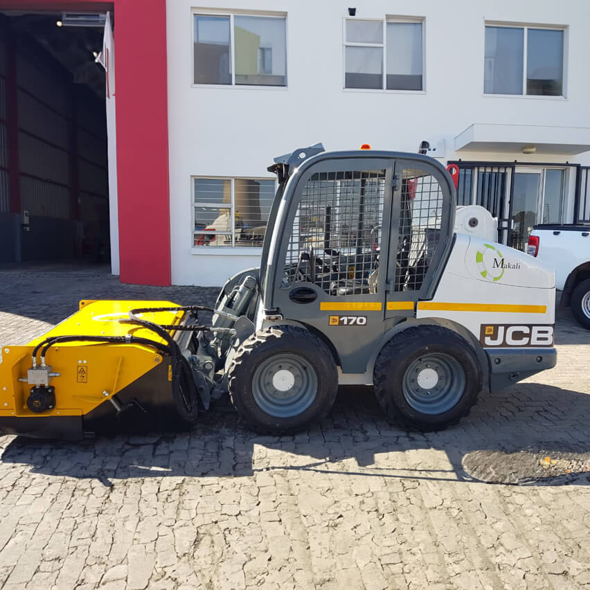 JCB broom in operation, demonstrating efficient road sweeping and maintenance as part of Makali Plant and Construction's equipment fleet.